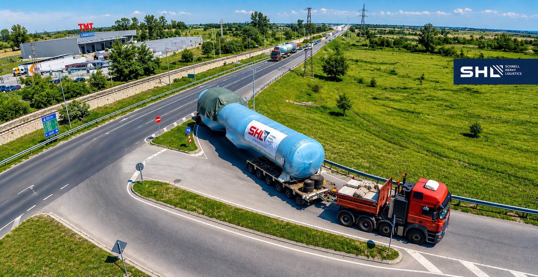 SHL heavy transport — oversized cargo on lowbed trailer, aerial view